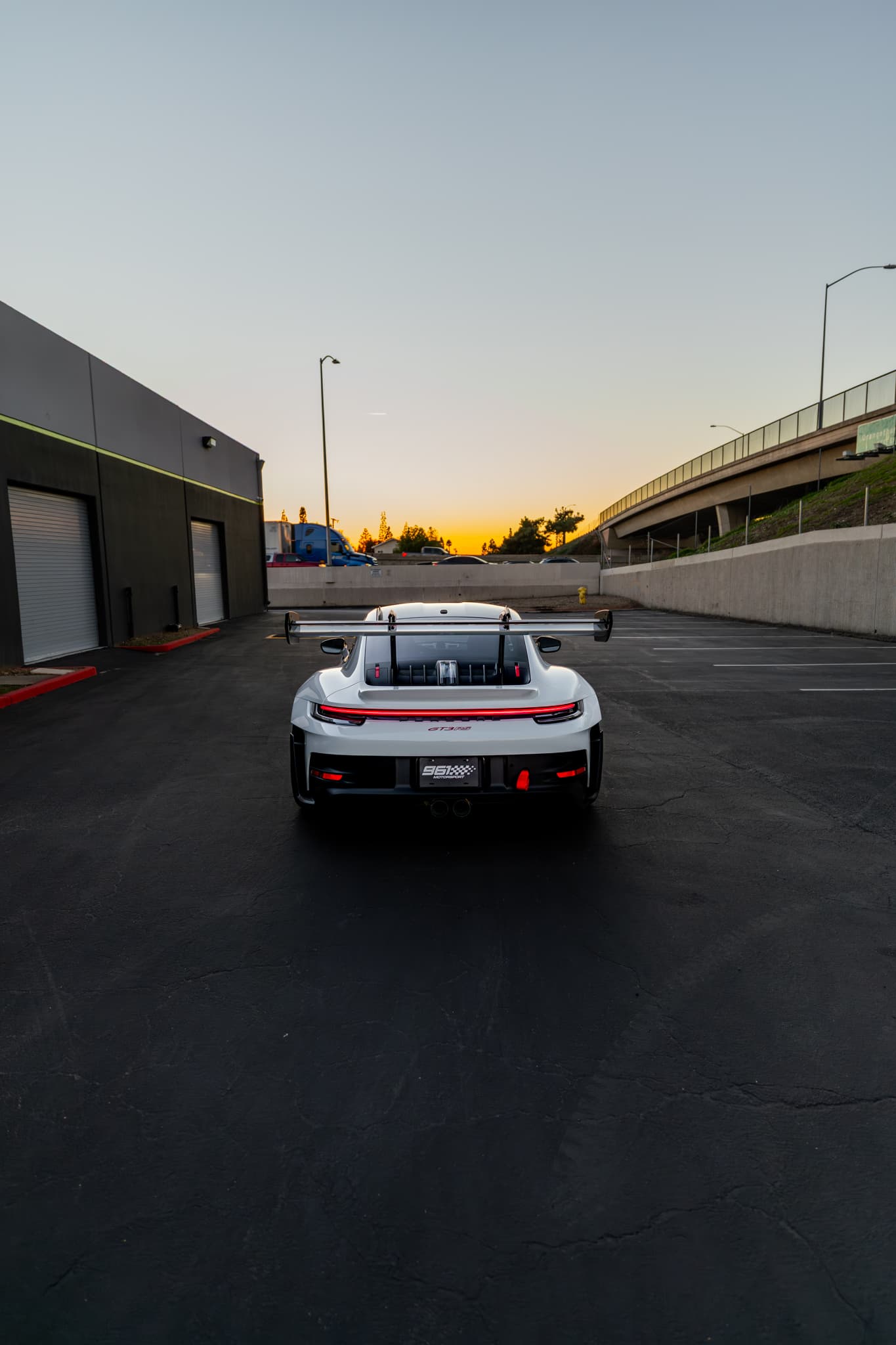 Porsche GT3 RS rear view at sunset outside the 961 facility